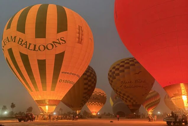 Hot air balloons being inflated before sunrise in Luxor, Egypt