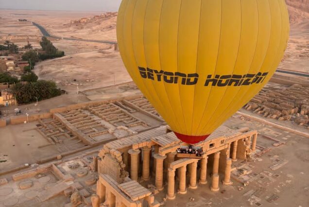 “Beyond Horizon” hot air balloon flying over Luxor, Egypt, with views of ancient temples and the desert landscape.