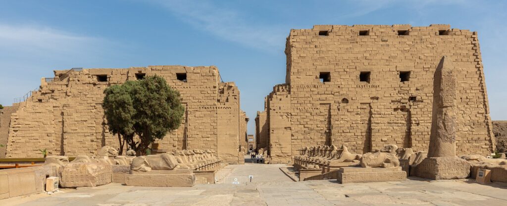 Entrance pylon of the Precinct of Amun-Re at Karnak Temple Complex, Luxor, Egypt, with an avenue of sphinxes.
