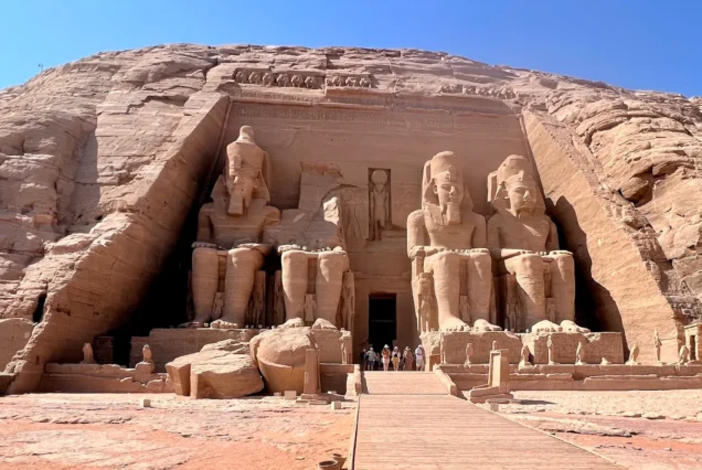 The Great Temple of Ramesses II at Abu Simbel with colossal seated statues carved into the cliff face.