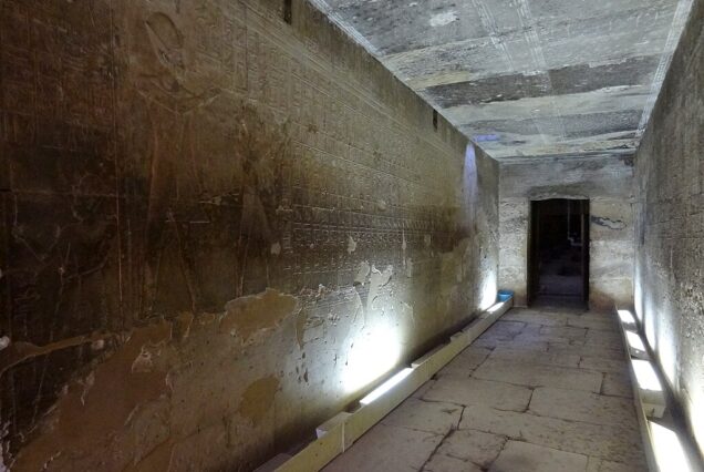 Passage with detailed wall reliefs inside the Temple of Seti I at Abydos, Egypt.