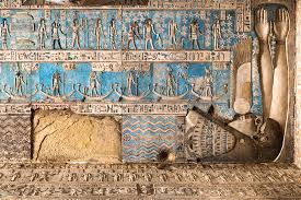 Vibrant ceiling with detailed hieroglyphs and astronomical engravings inside the Temple of Hathor at Dendera, Egypt.