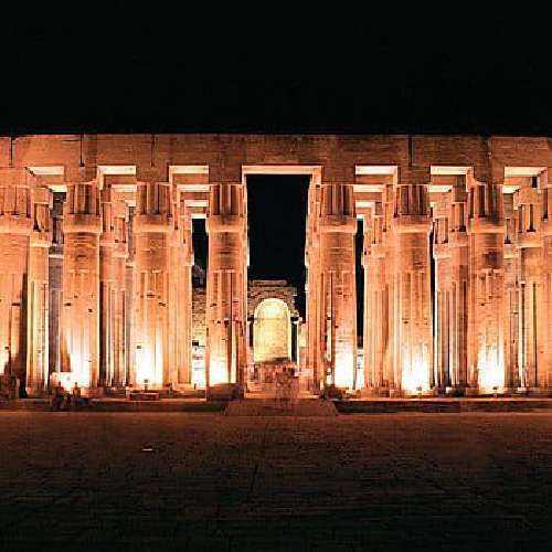 Luxor Temple illuminated at night, showcasing its ancient Egyptian architectural details.