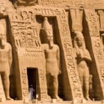 Facade of the Small Temple at Abu Simbel featuring six colossal statues of Ramesses II and Queen Nefertari.