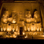 The Great Temple of Abu Simbel with four colossal seated statues of Ramesses II carved into the cliff face in southern Egypt.
