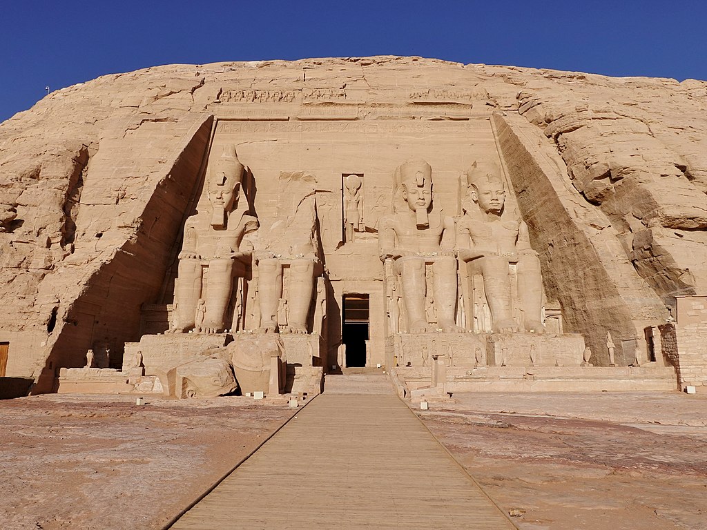 The Abu Simbel Temples in southern Egypt, with four colossal seated statues of Pharaoh Ramesses II carved into the rock façade.