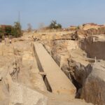 The Unfinished Obelisk lying horizontally in the granite quarry at Aswan, showing visible cracks and tool marks.