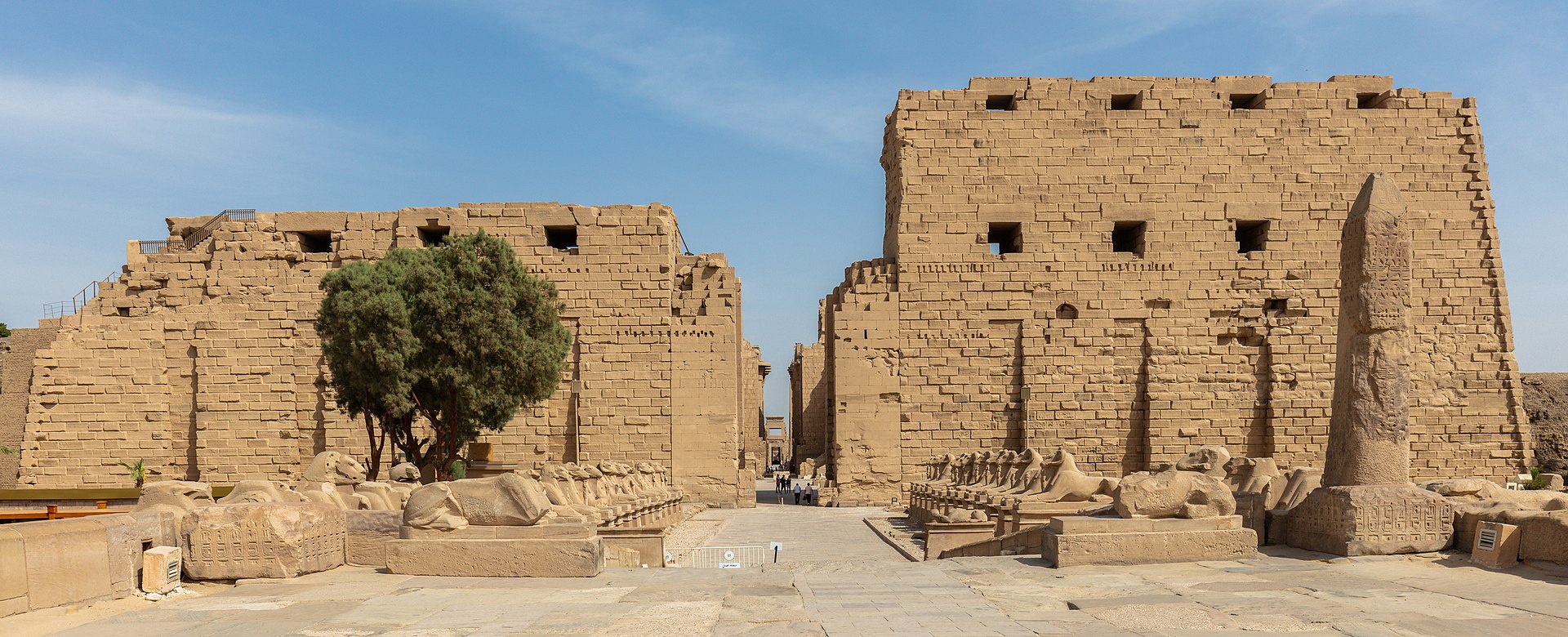 Entrance to the Precinct of Amun-Re at the Karnak Temple Complex in Luxor, Egypt, with the avenue of ram-headed sphinxes leading to the first pylon.