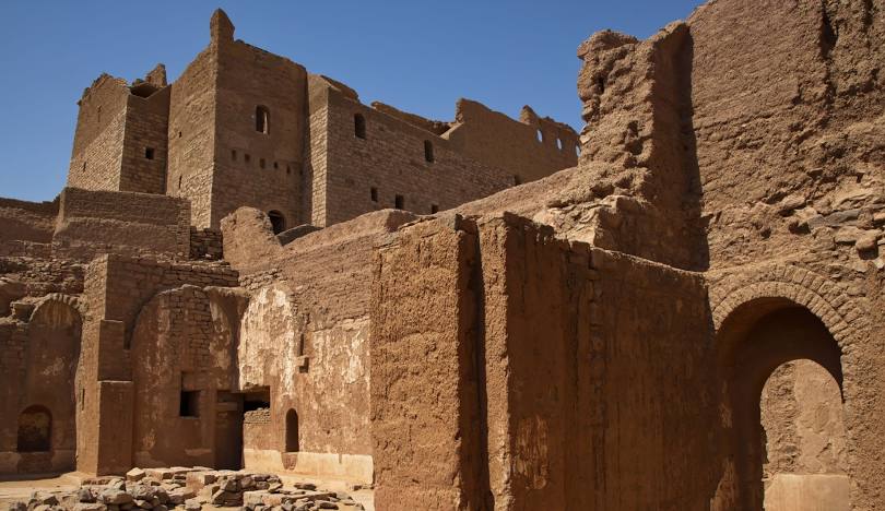 View of the Monastery of St. Simeon in Aswan, an ancient Coptic Orthodox fortress-like structure built of stone and mud brick.