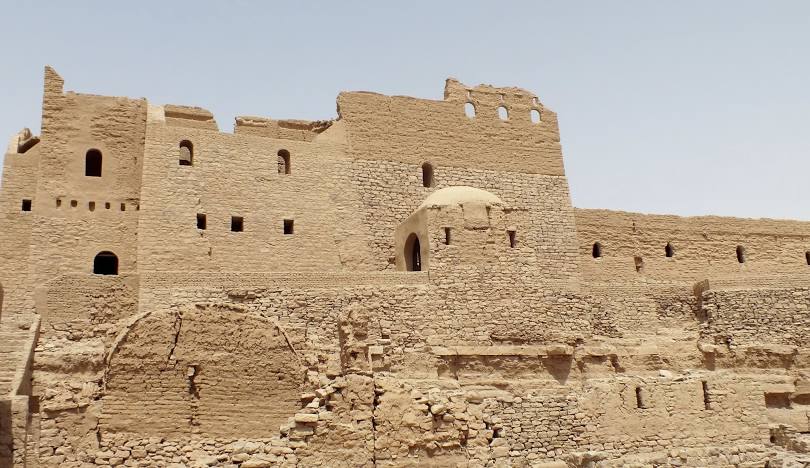 View of the Monastery of St. Simeon in Aswan, an ancient Coptic Orthodox fortress-like structure built of stone and mud brick.