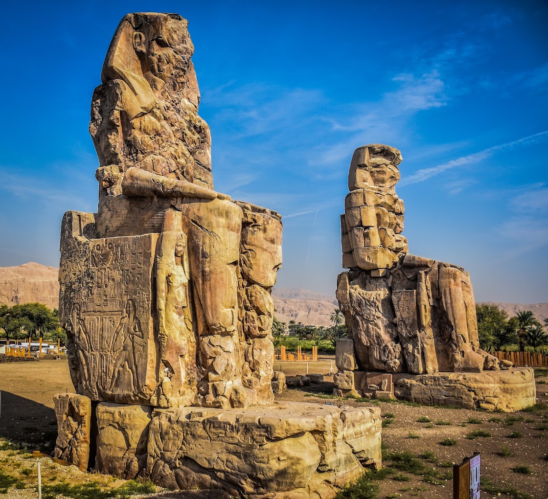 The Colossi of Memnon, two massive seated stone statues on the west bank of the Nile near Luxor, Egypt
