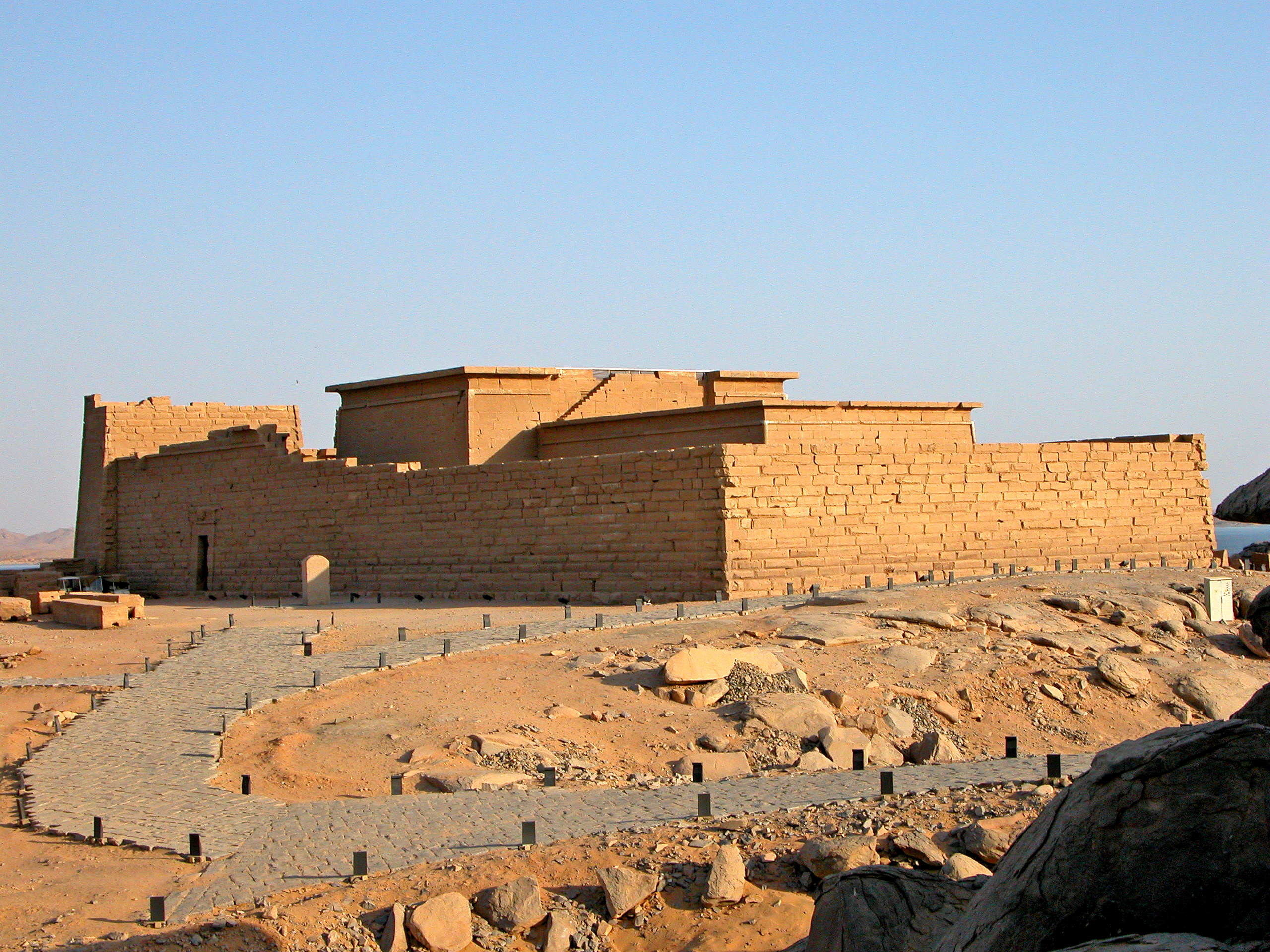 Exterior view of the Temple of Kalabsha on New Kalabsha Island near Aswan, Egypt, showcasing its monumental sandstone walls and pylons.