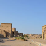 Philae Temple View of Philae Temple on Agilkia Island near Aswan, Egypt, showing its ancient stone structures surrounded by water.