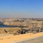 The High Dam Aerial view of the Aswan High Dam spanning the Nile River near Aswan, Egypt, with Lake Nasser visible behind it.