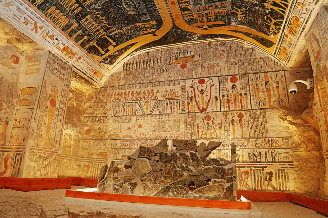 Interior of a tomb in the Valley of the Kings, Luxor, Egypt, with colorful wall paintings and hieroglyphs from the New Kingdom.