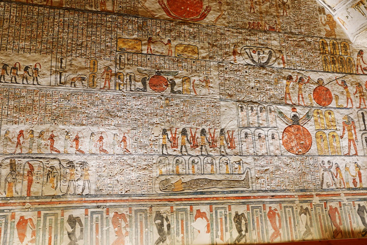 Hieroglyphic carvings and colorful paintings inside a tomb in the Valley of the Kings, Luxor, Egypt.