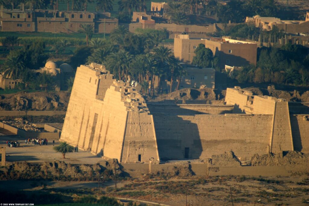 The Mortuary Temple of Ramesses III at Medinet Habu in Luxor, featuring colossal statues, detailed reliefs, and grand courtyards on the West Bank of the Nile.