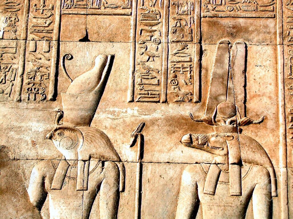 A relief from the Temple of Kom Ombo in Egypt showing the gods Horus with a falcon head and Sobek with a crocodile head.