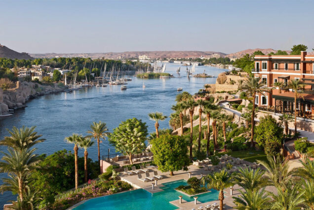 The Sofitel Legend Old Cataract Aswan, a historic Victorian-era luxury hotel on the Nile River with views of Elephantine Island.