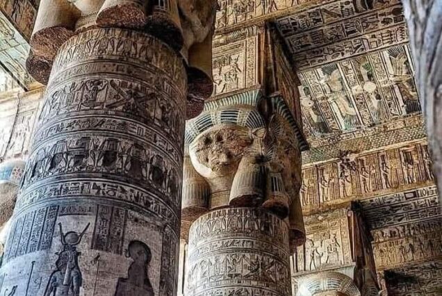 Interior view of the Temple of Hathor at the Dendera Temple Complex, showing massive columns with Hathor-headed capitals.