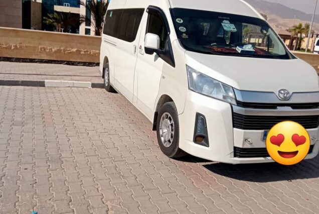 White Toyota HiAce van, a versatile light commercial vehicle popular for passenger and cargo transport.