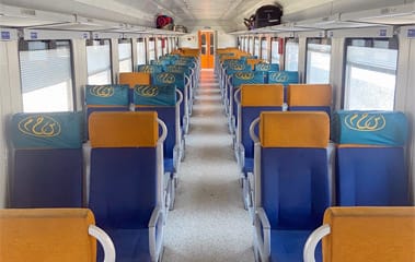 Interior of an Egyptian National Railways (ENR) passenger coach, part of Africa and the Middle East’s first railway system, with modern ticketing and station facilities.