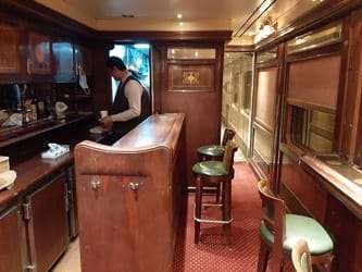 Lounge car of an Egyptian sleeper train between Cairo and Luxor or Aswan, offering seating for relaxation and socialization outside private cabins.
