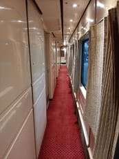 Interior corridor of a Talgo luxury train in Egypt with red carpet and windows, part of the country’s modernized railway fleet introduced in 2022.