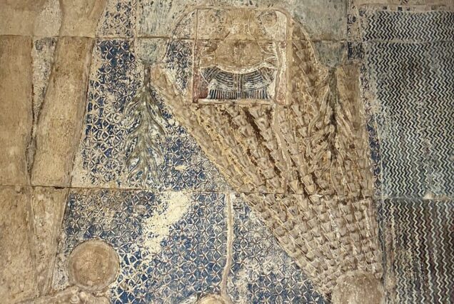 Well-preserved wall relief at the Dendera Temple Complex in Egypt, depicting intricate carvings from the Ptolemaic and Roman periods.
