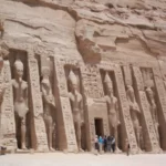 Exterior view of the Small Temple of Abu Simbel (Temple of Hathor and Nefertari) in Egypt, with statues and stone facade.