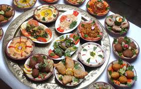 A variety of traditional Egyptian dishes including Ful, Koshary, Mahshii, and meat dishes served in bowls.