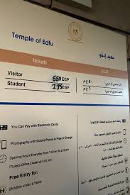 A panel displaying ticket prices and visitor information for Edfu Temple in Egypt.