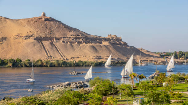 Qubbet el-Hawa, an ancient necropolis on the west bank of the Nile near Aswan, with rock-cut tombs in the cliffs overlooking the river.