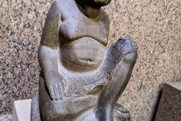 Green basalt block statue of Harwa, Chief Steward of the God’s Wife of Amun during Egypt’s 25th Dynasty, inscribed with hieroglyphic text.