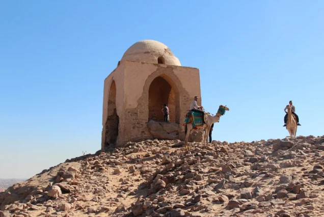 Qubbet el-Hawa necropolis on the west bank of the Nile in Aswan, Egypt, with rock-cut tombs and panoramic views from the cliffs.