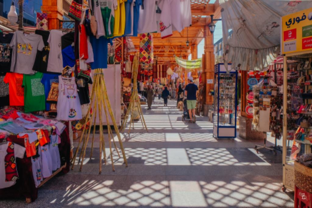 "Bustling Aswan Souq in Egypt, with colorful stalls selling spices, crafts, and traditional goods."