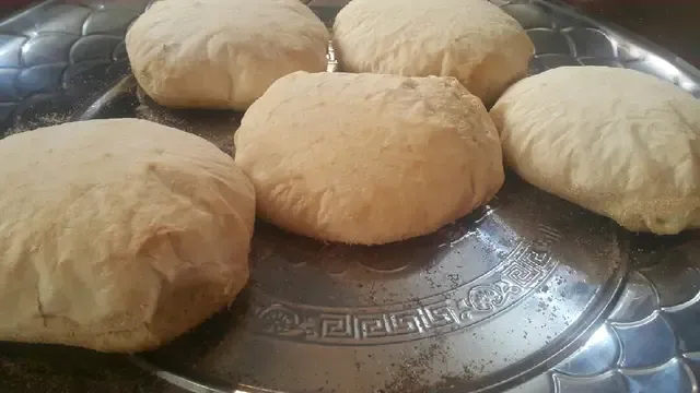 "Eish Shamsi, a traditional thick round sourdough bread from Upper Egypt, with distinctive bumps baked in a domed oven."
