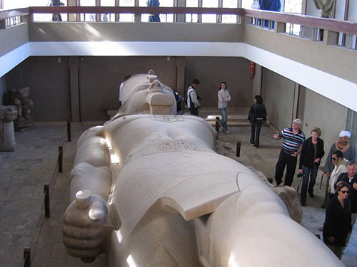 This image shows the colossal statue of Ramesses II housed in the Memphis Museum in Mit Rahina, Egypt.