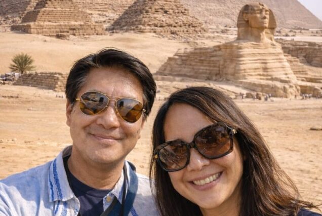 Couple in front of pyramids.